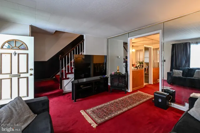 a view of a dining room with furniture and a potted plant