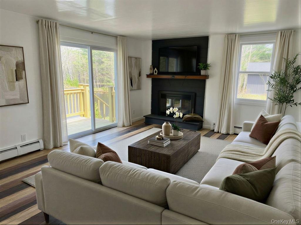 273 Blind Pond Road Narrowsburg, NY 12764 - Photo 12 of 29 a living room with furniture and a fireplace