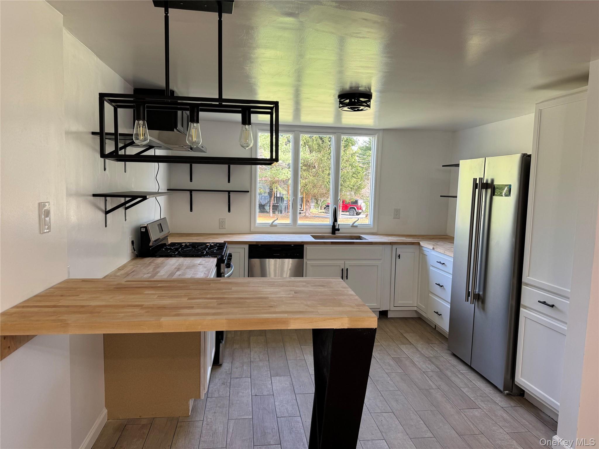 273 Blind Pond Road Narrowsburg, NY 12764 - Photo 7 of 29 a kitchen with stainless steel appliances a sink and cabinets