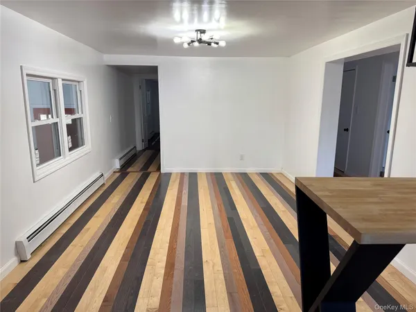a view of a bedroom with wooden floor and a sink