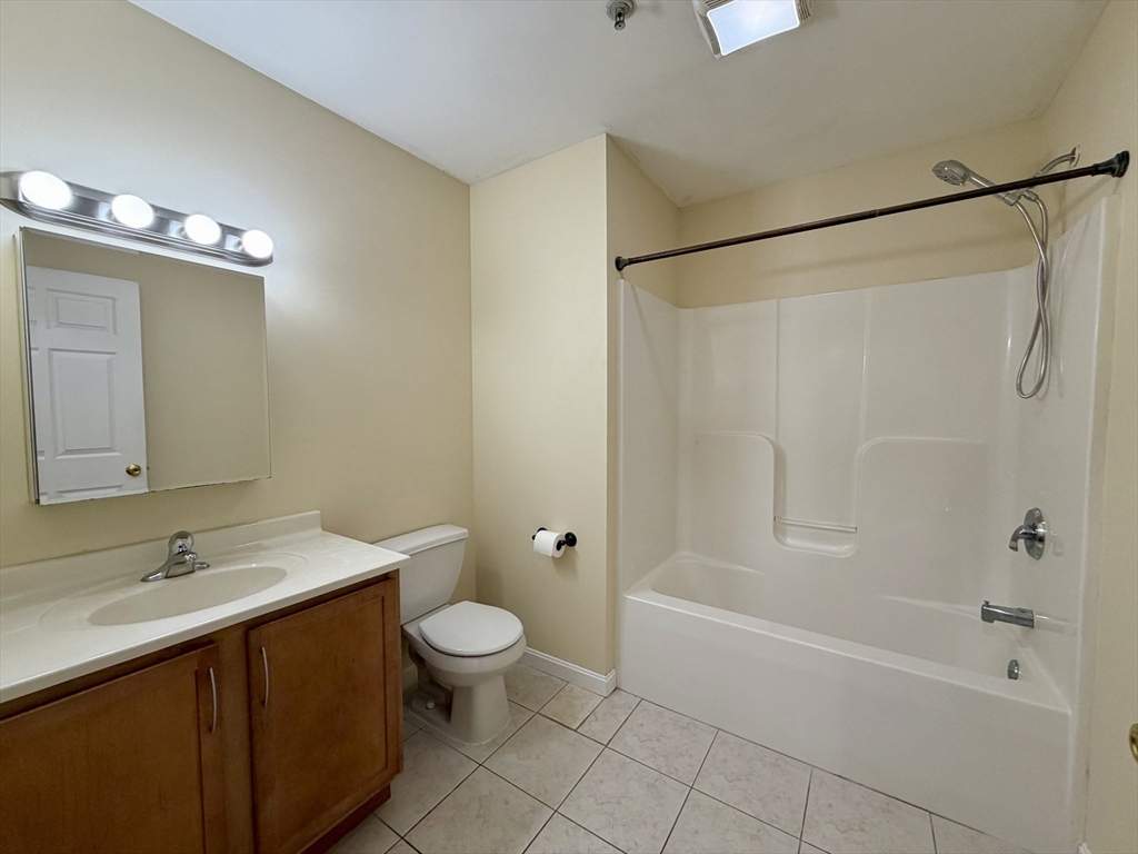 75 Walnut Street, Unit 312 Peabody, MA 01960 - Photo 9 of 16 a bathroom with a sink a toilet and shower