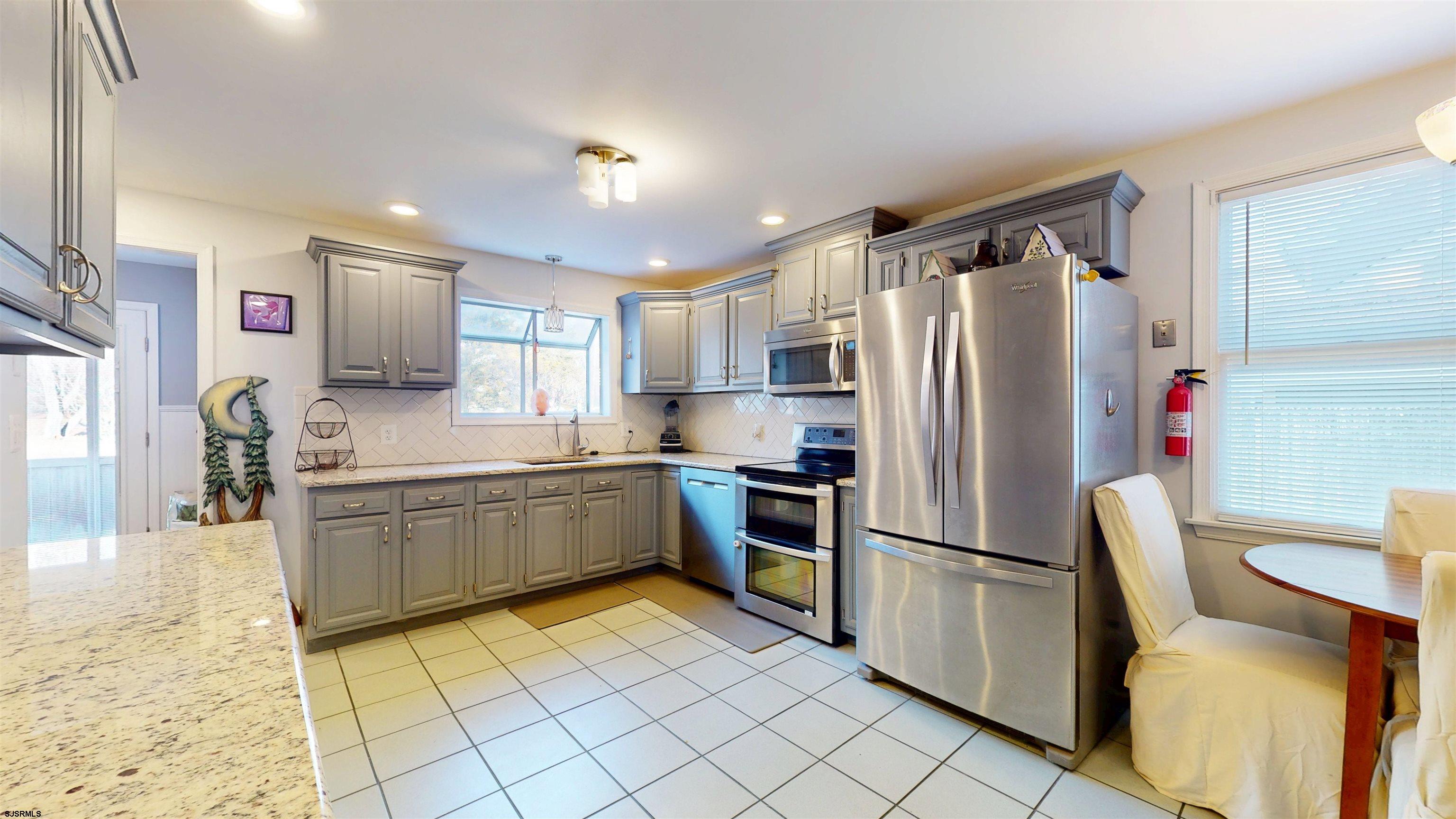 64 Clarks Landing Road Port Republic, NJ 08241 - Photo 11 of 63 a kitchen with granite countertop a refrigerator and a sink
