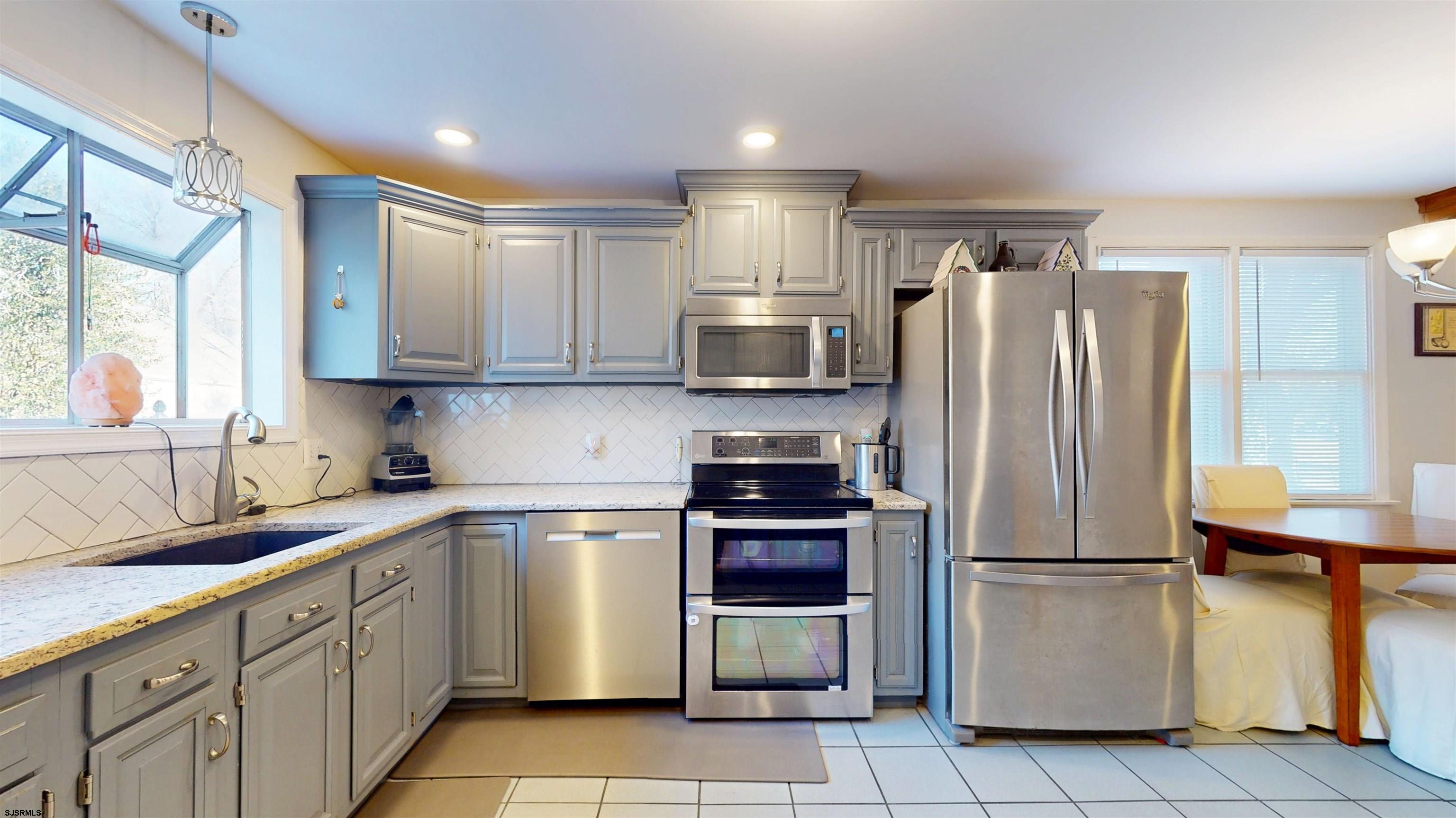 64 Clarks Landing Road Port Republic, NJ 08241 - Photo 13 of 63 a kitchen with stainless steel appliances granite countertop a refrigerator sink and stove