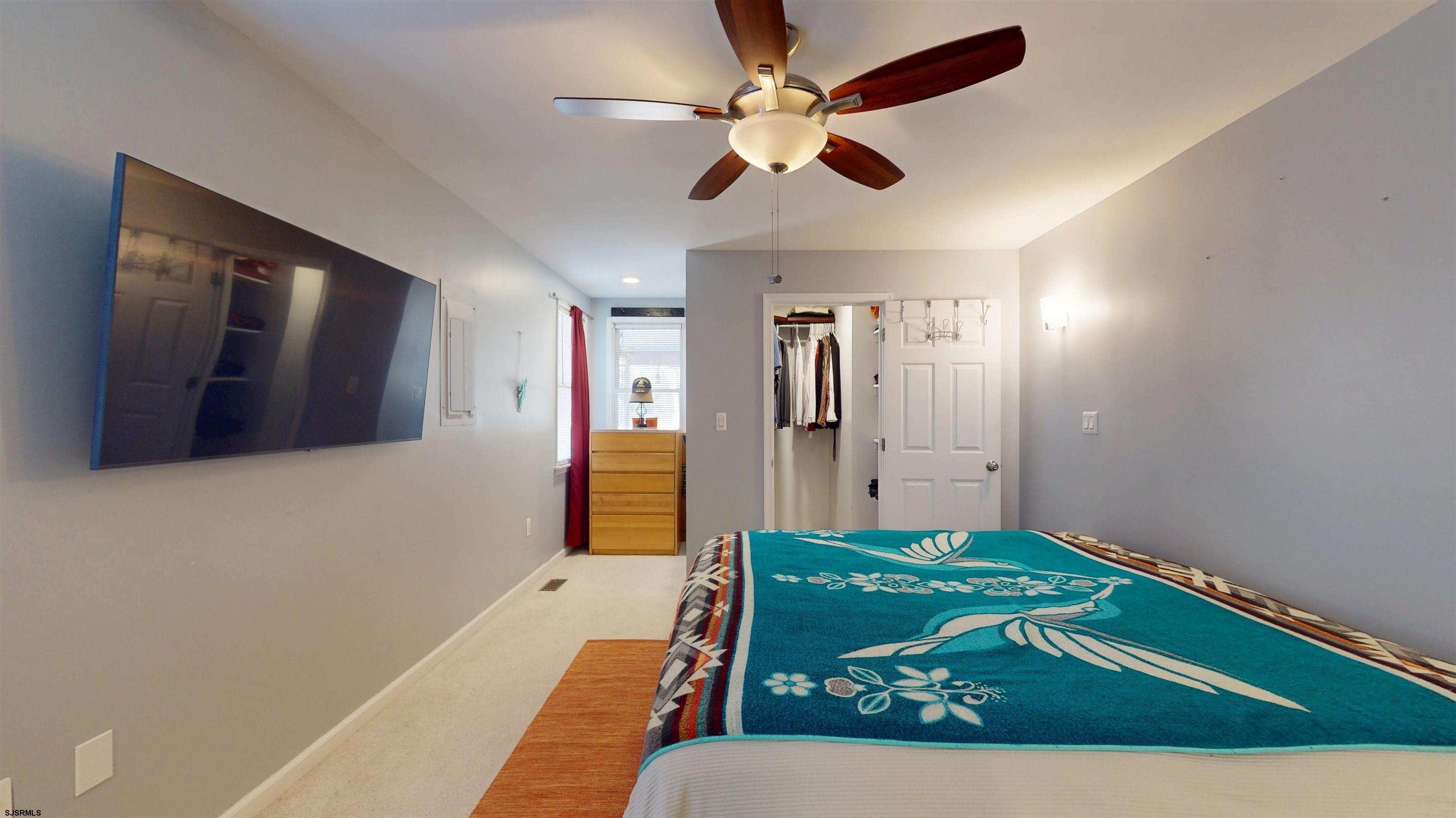 64 Clarks Landing Road Port Republic, NJ 08241 - Photo 22 of 63 a bedroom with a large bed and a chandelier