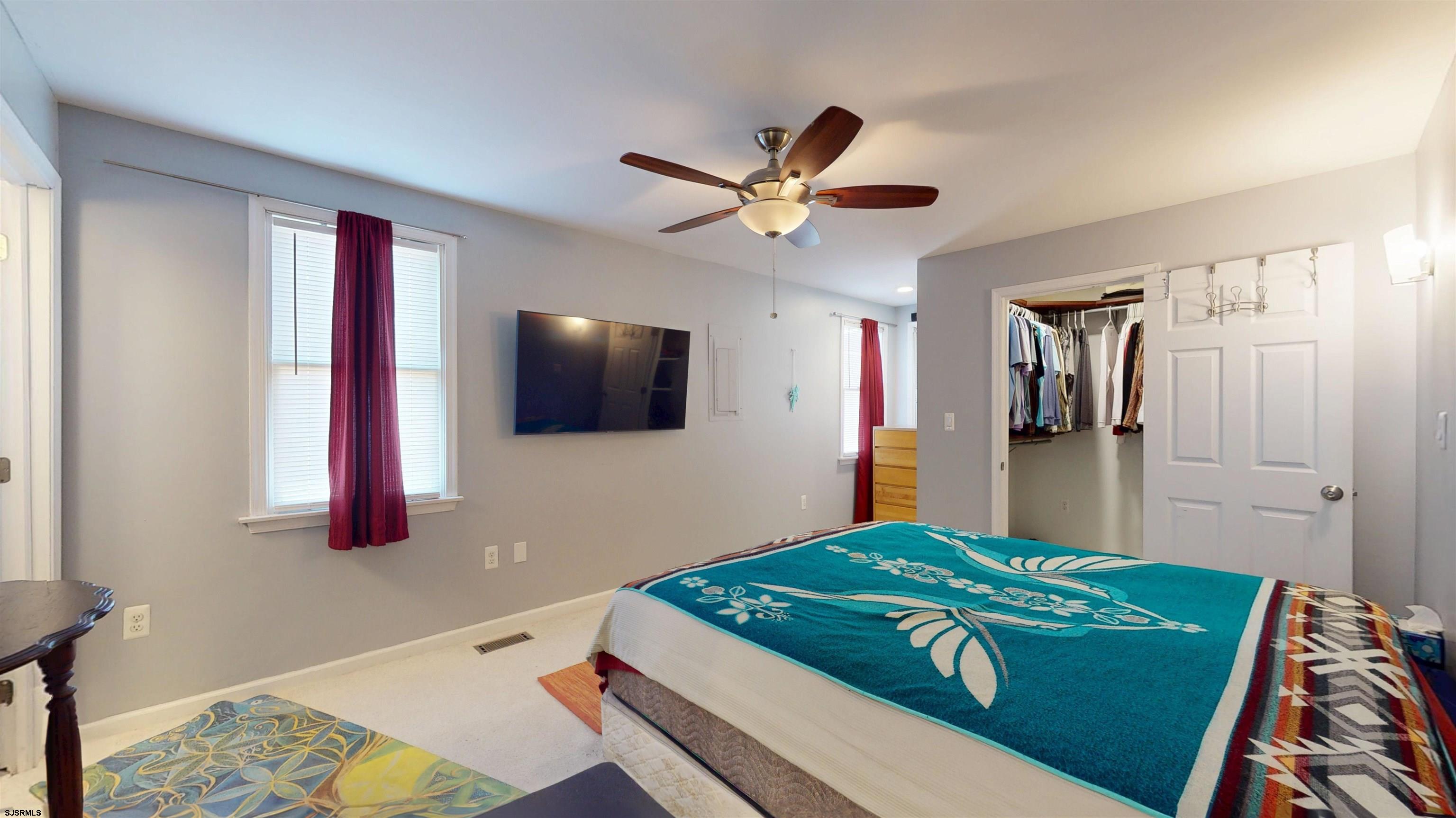 64 Clarks Landing Road Port Republic, NJ 08241 - Photo 24 of 63 a bedroom with a bed and a flat screen tv