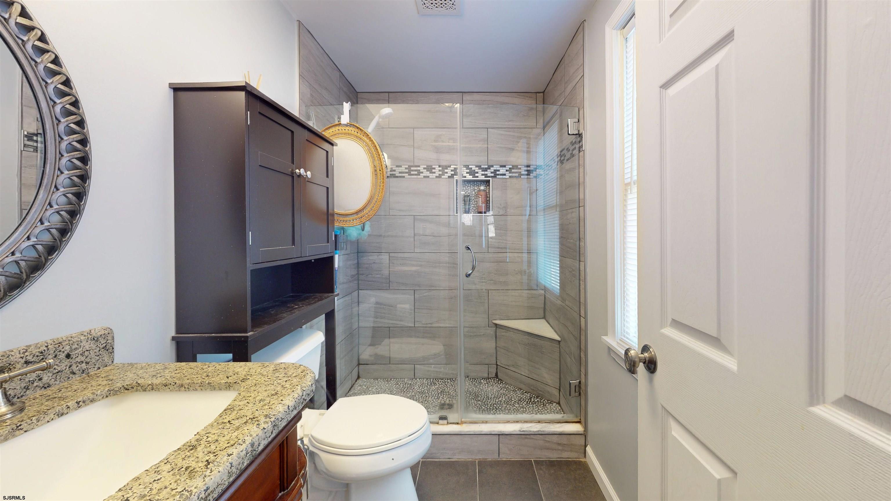 64 Clarks Landing Road Port Republic, NJ 08241 - Photo 28 of 63 a bathroom with a granite countertop sink toilet and shower