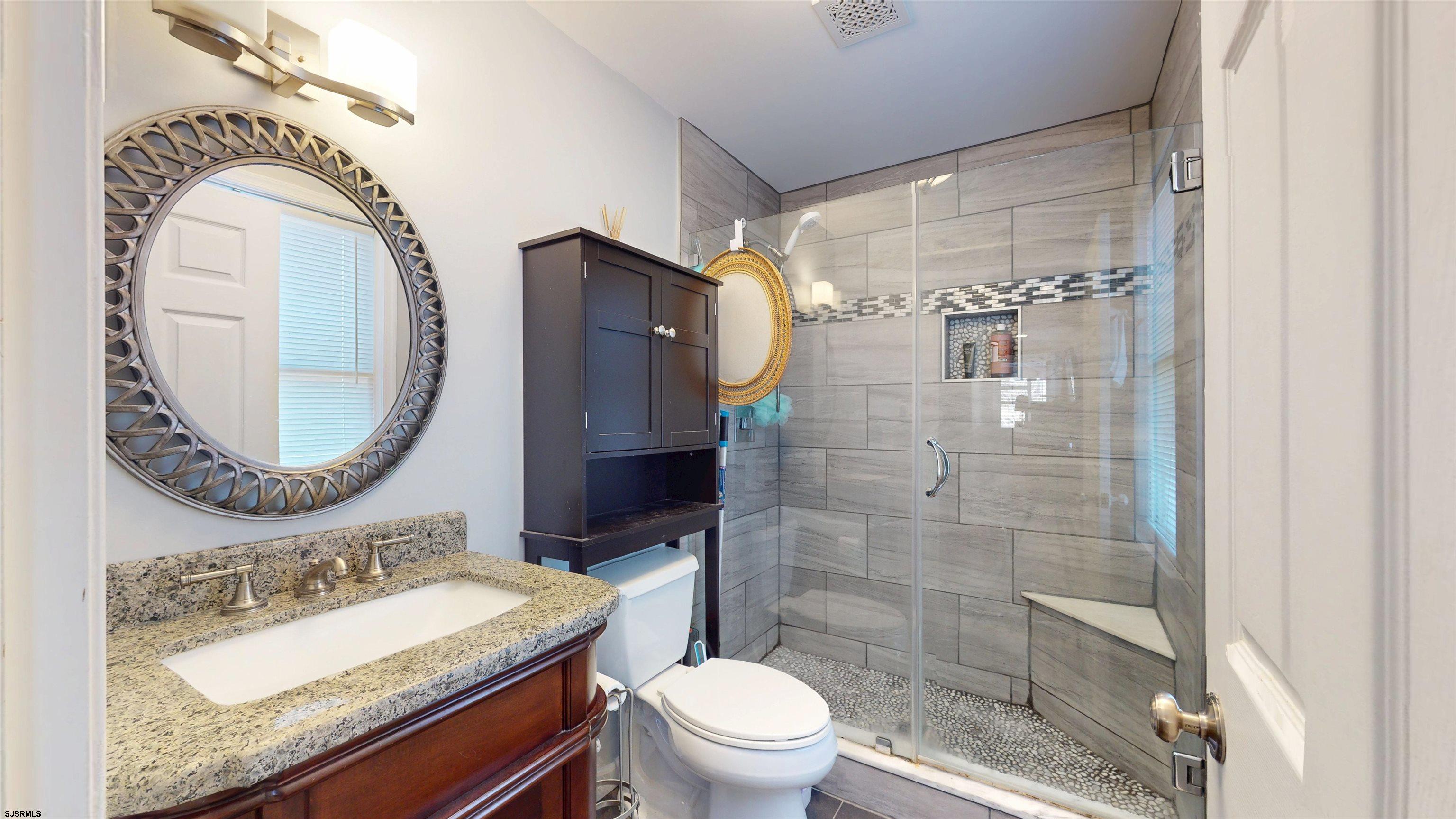 64 Clarks Landing Road Port Republic, NJ 08241 - Photo 29 of 63 a bathroom with a sink a toilet and a mirror