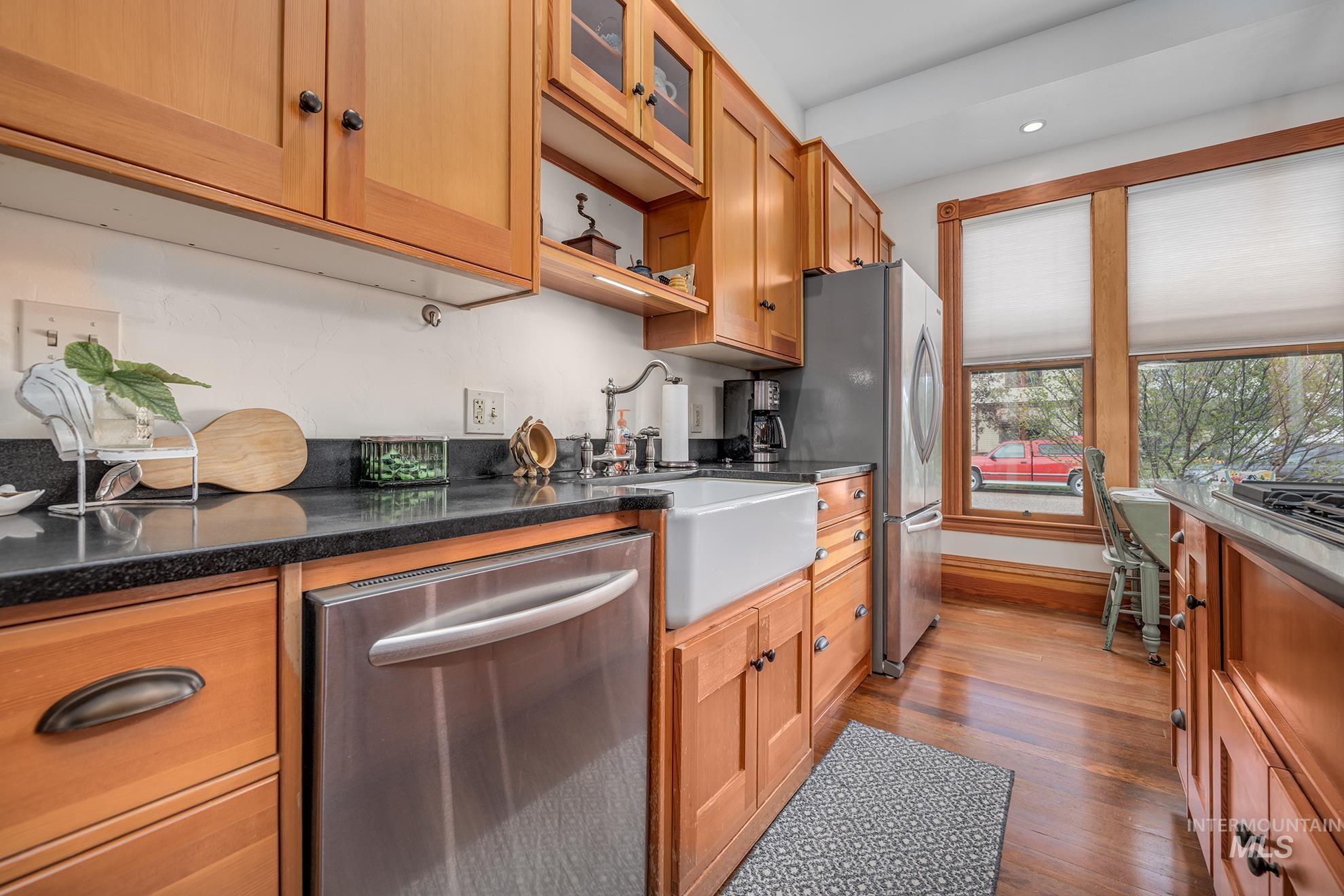 548 West 2nd Street Weiser, ID 83672 - Photo 12 of 50 Kitchen featuring stainless steel appliances, dark wood-style floors, recessed lighting, dark stone counters, and glass insert cabinets