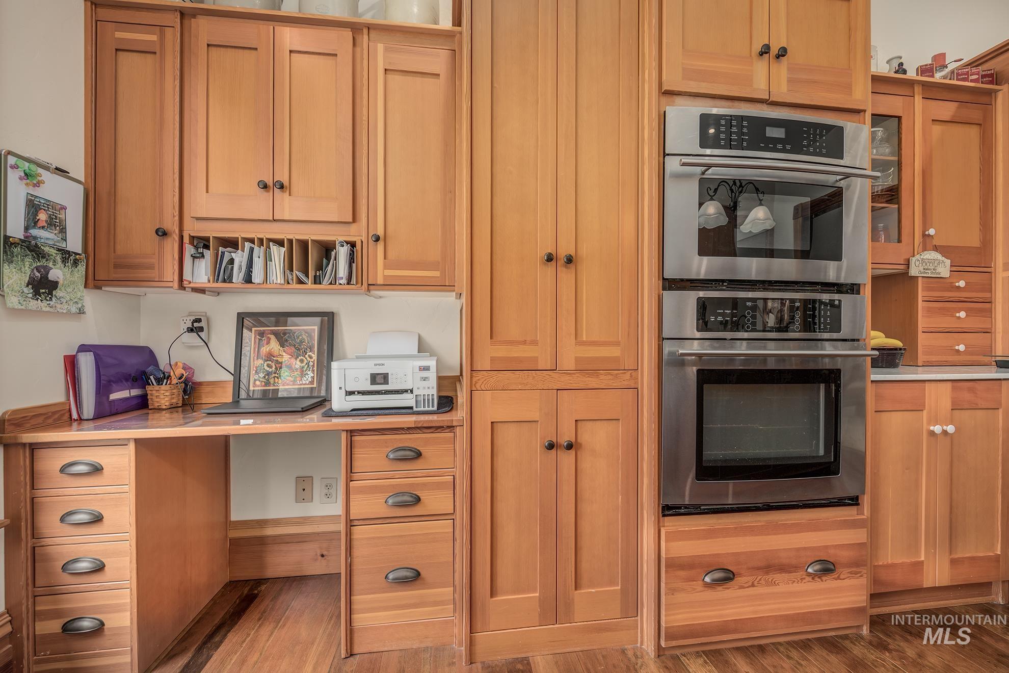 548 West 2nd Street Weiser, ID 83672 - Photo 13 of 50 Kitchen with stainless steel double oven, wood finished floors, and light countertops