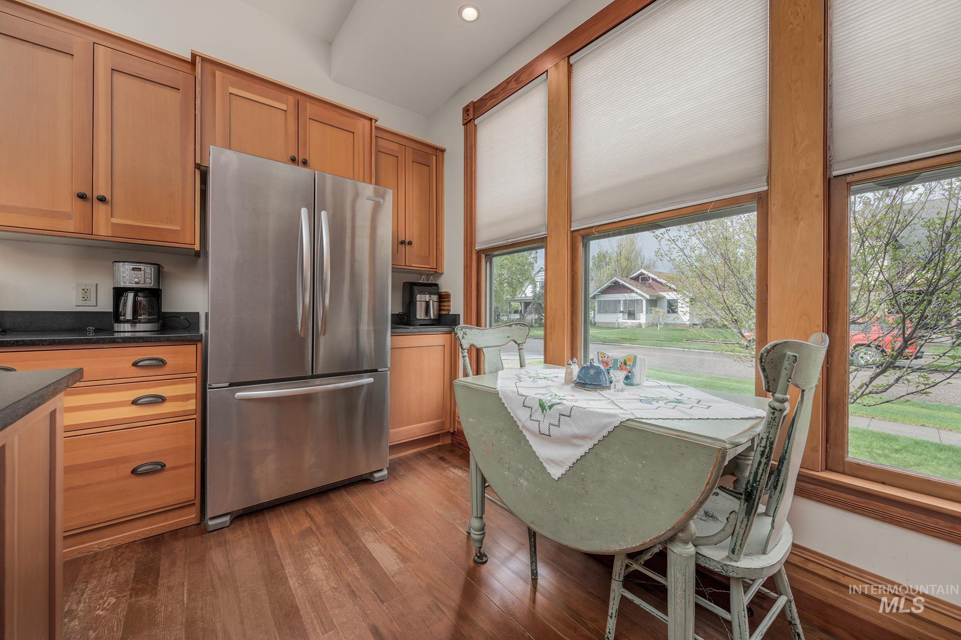 548 West 2nd Street Weiser, ID 83672 - Photo 15 of 50 Kitchen featuring freestanding refrigerator, dark wood-style floors, and wood finish cabinetry