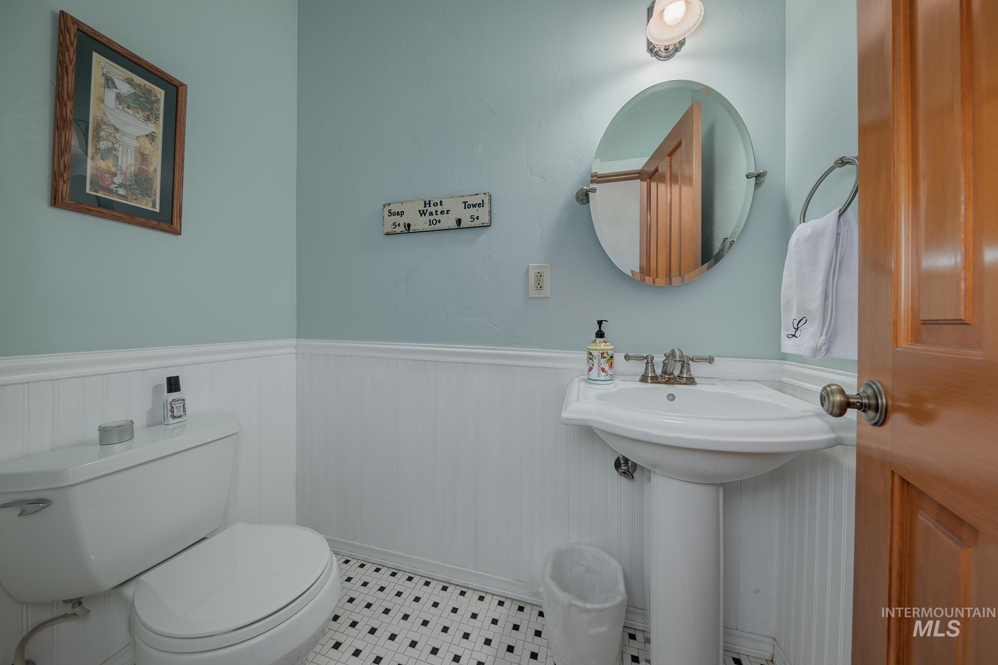 548 West 2nd Street Weiser, ID 83672 - Photo 16 of 50 Half bathroom featuring toilet and a wainscoted wall