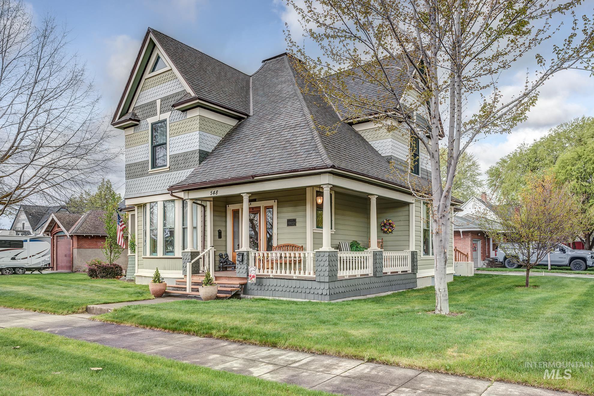 548 West 2nd Street Weiser, ID 83672 - Photo 2 of 50 Victorian-style house with covered porch, a front lawn, and a shingled roof