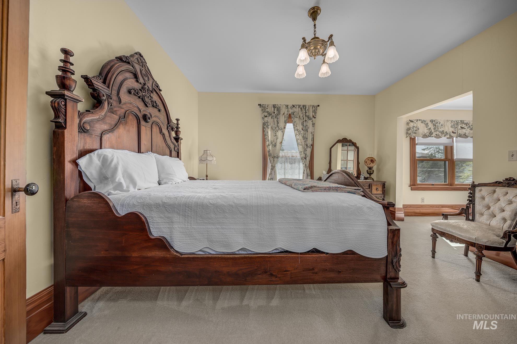 548 West 2nd Street Weiser, ID 83672 - Photo 24 of 50 Bedroom with suspended lighting and light carpet