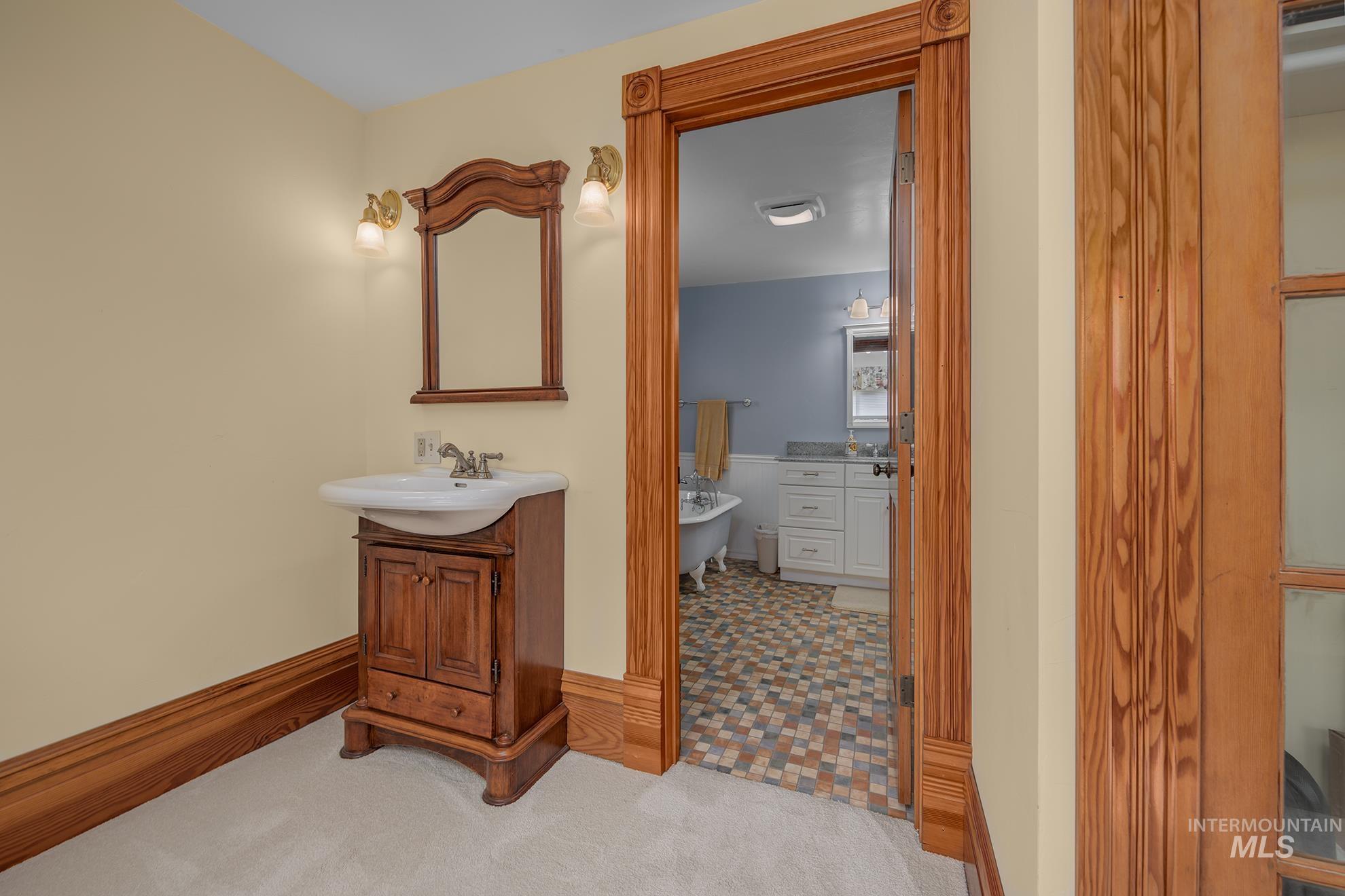 548 West 2nd Street Weiser, ID 83672 - Photo 26 of 50 Bathroom with two vanities and light carpet