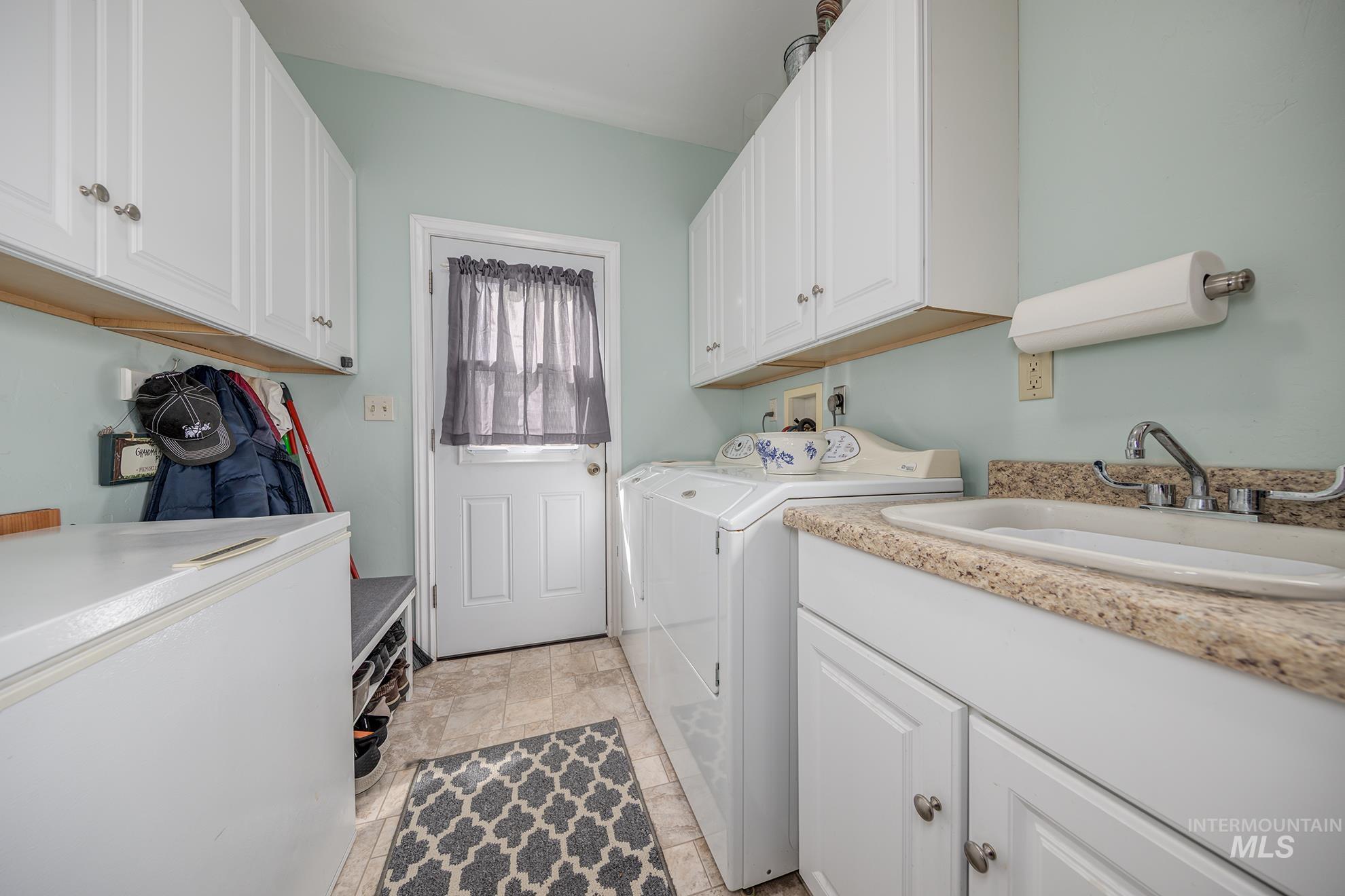 548 West 2nd Street Weiser, ID 83672 - Photo 34 of 50 Laundry room featuring cabinet space and washing machine and clothes dryer