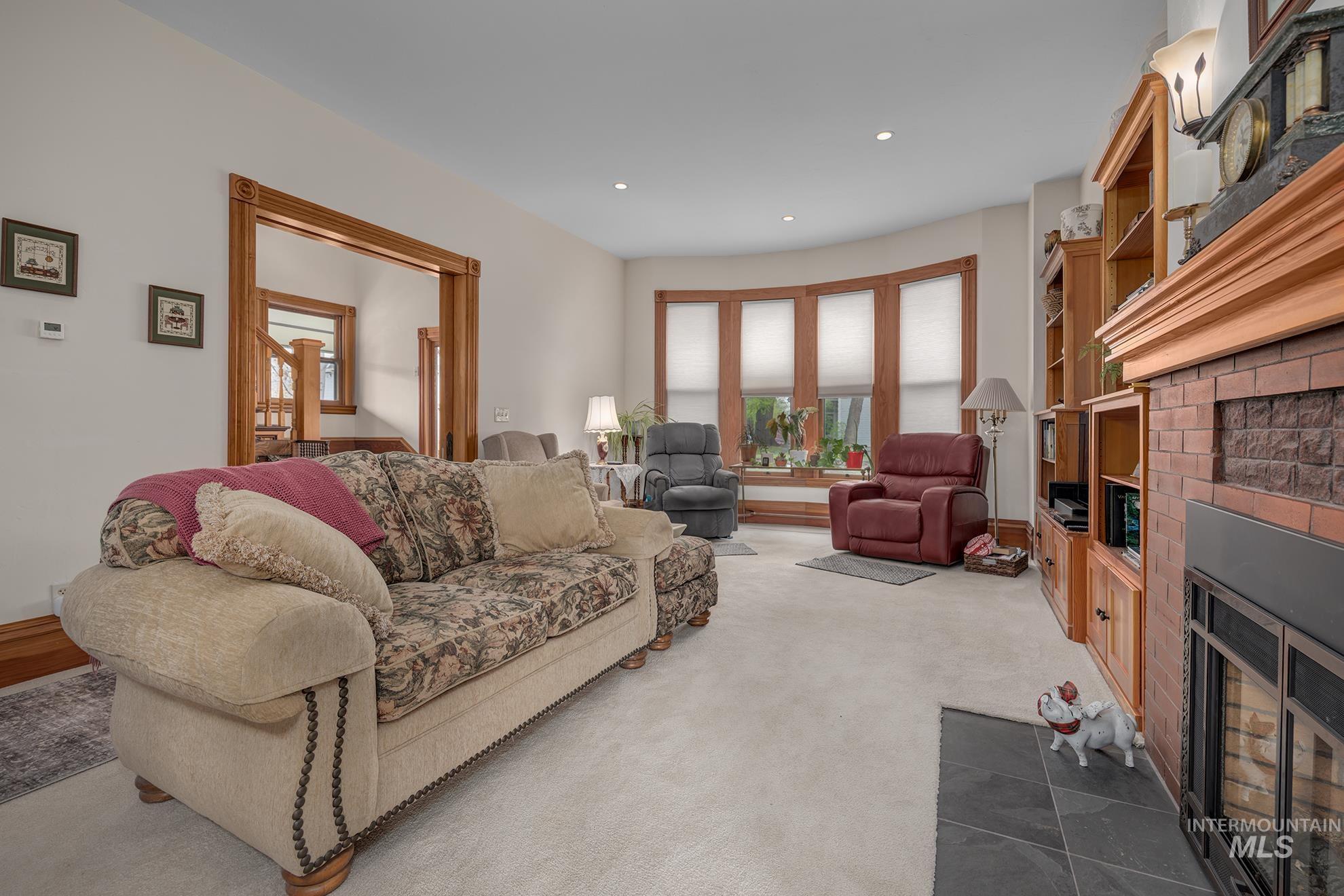 548 West 2nd Street Weiser, ID 83672 - Photo 6 of 50 Living area with a fireplace with flush hearth, recessed lighting, and dark carpet