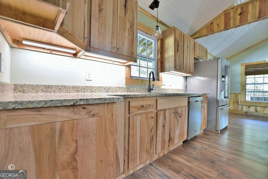3175 Salem Road Pine Mountain, GA 31822 - Photo 21 of 41 a kitchen with stainless steel appliances granite countertop a sink and dishwasher cabinets with wooden floor