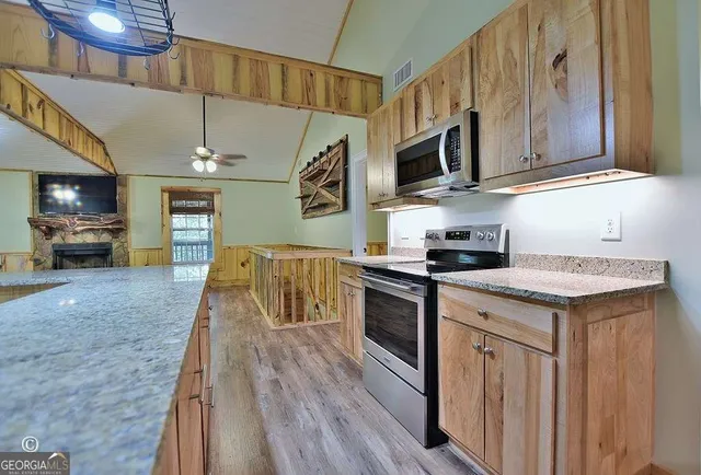 a kitchen with stainless steel appliances granite countertop a stove and a sink