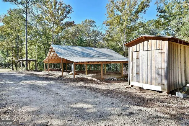 a backyard of a house with table and chairs