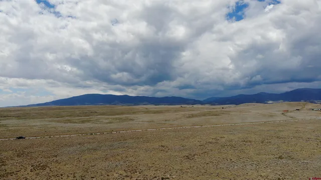 a view of an ocean beach and mountain