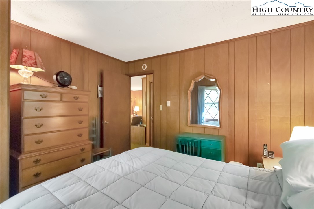 206 Oak Road Beech Mountain, NC 28604 - Photo 11 of 22 a bedroom with a bed and a window