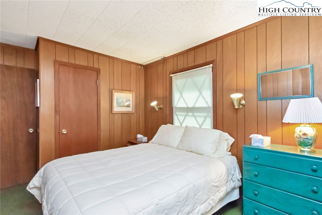 206 Oak Road Beech Mountain, NC 28604 - Photo 19 of 22 a bedroom with a bed and a window