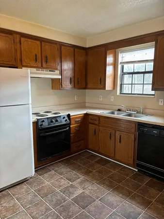 a kitchen with a sink stove and microwave