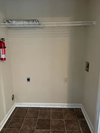 a view of a room with wooden floor and utility room