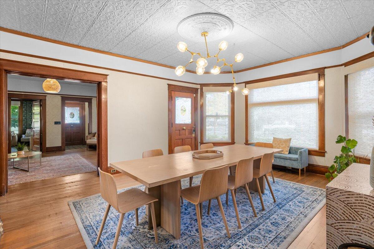 139 Southwest I Street Grants Pass, OR 97526 - Photo 17 of 47 a view of a dining room with furniture wooden floor and chandelier