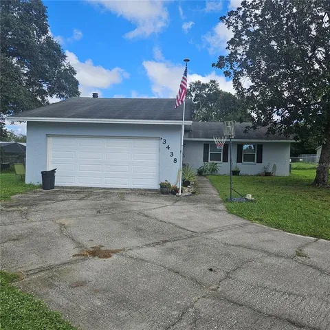 a front view of a house with a yard and a garage