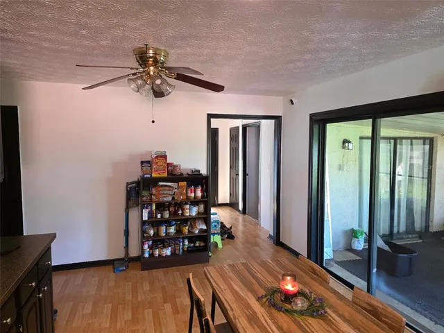 a living room with wooden floor furniture and a window