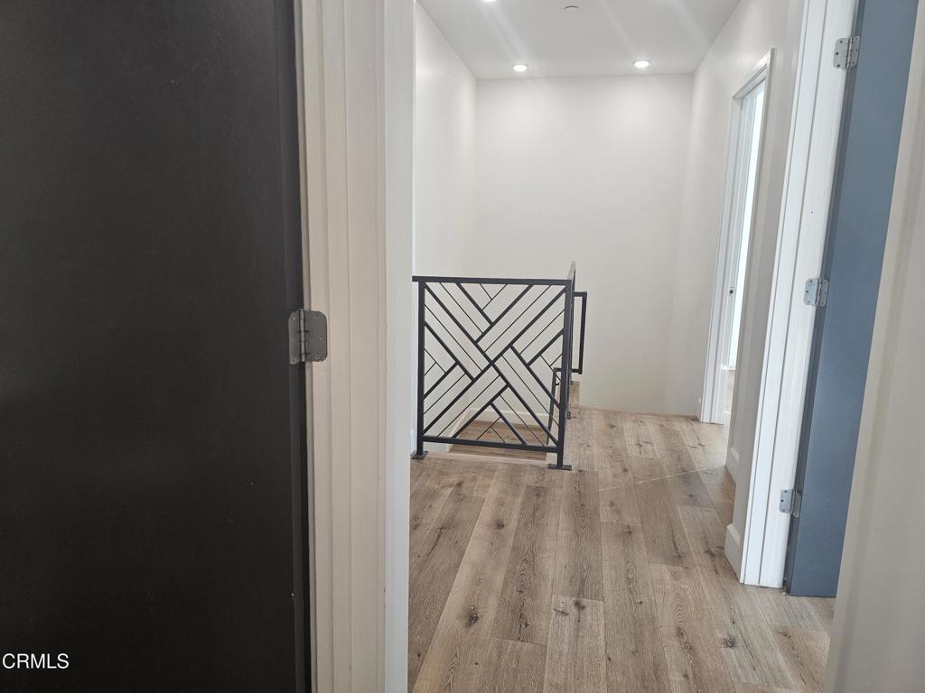 14550 Burbank Boulevard, Unit 103 Sherman Oaks, CA 91411 - Photo 22 of 27 a view of an empty room with wooden floor and a window