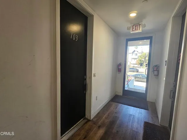 a view of hallway with wooden floor