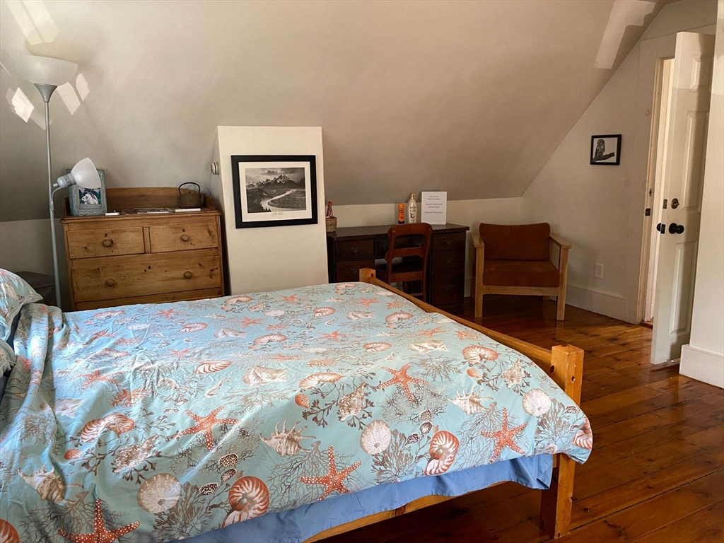 8 May Street Beverly, MA 01915 - Photo 13 of 25 a bedroom with a bed and wooden floor