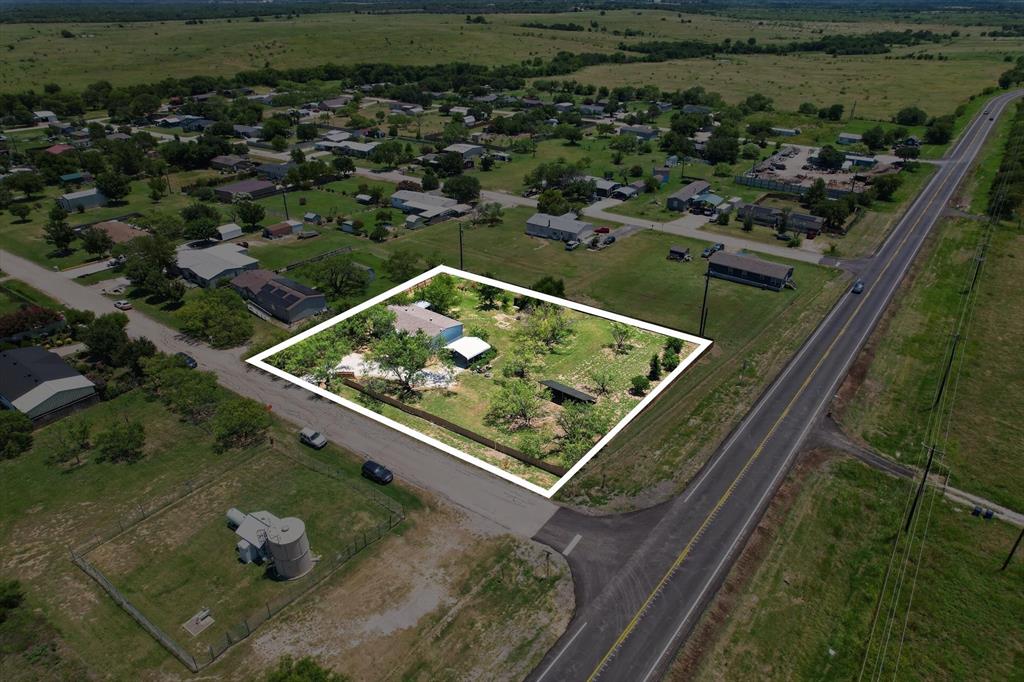 736 Little Joe Road Sanger, TX 76266 - Photo 1 of 17 Expansive lot with mature trees, featuring a single-story residence and a detached carport