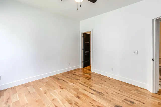 a view of an empty room with wooden floor