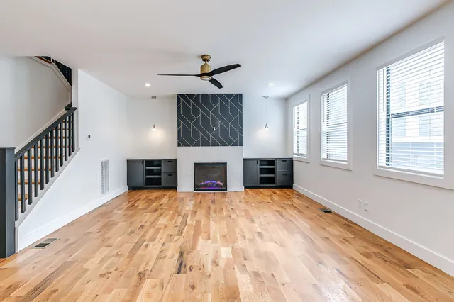 a view of an empty room with window and fireplace