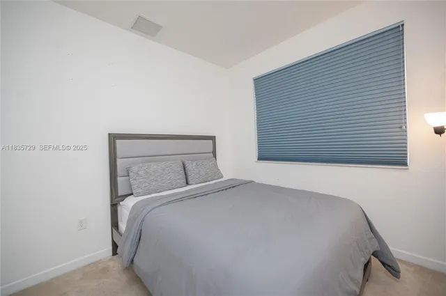 a bedroom with a bed and a mirror