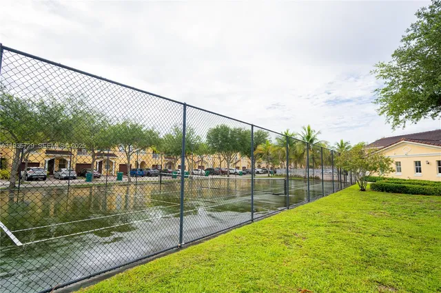 a view of a swimming pool with a patio and a garden