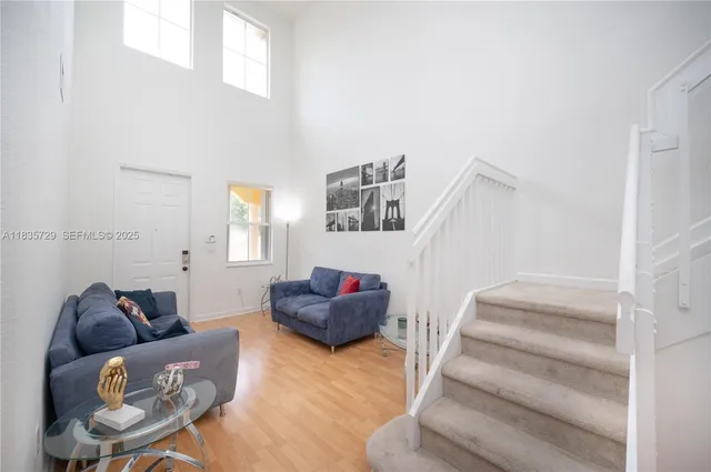 a living room with furniture and stairs