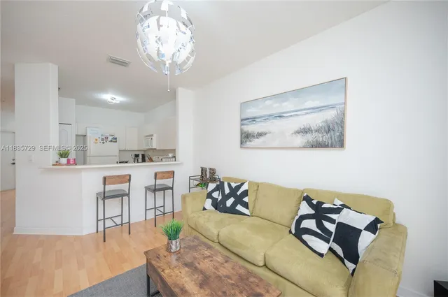 a living room with furniture and a chandelier
