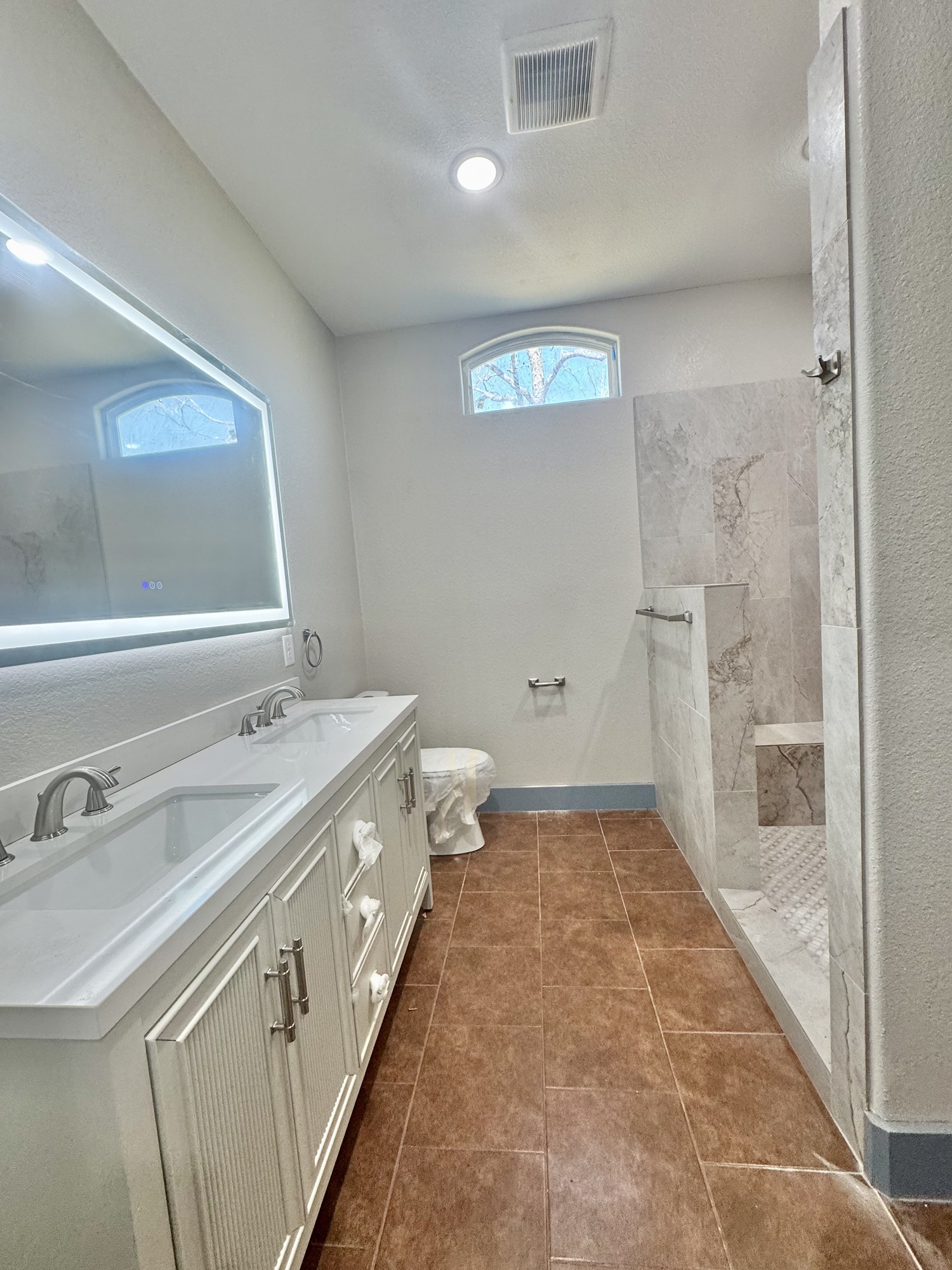 119 North 8th Street Beasley, TX 77417 - Photo 15 of 38 Double sinks in primary bedroom with LED mirror