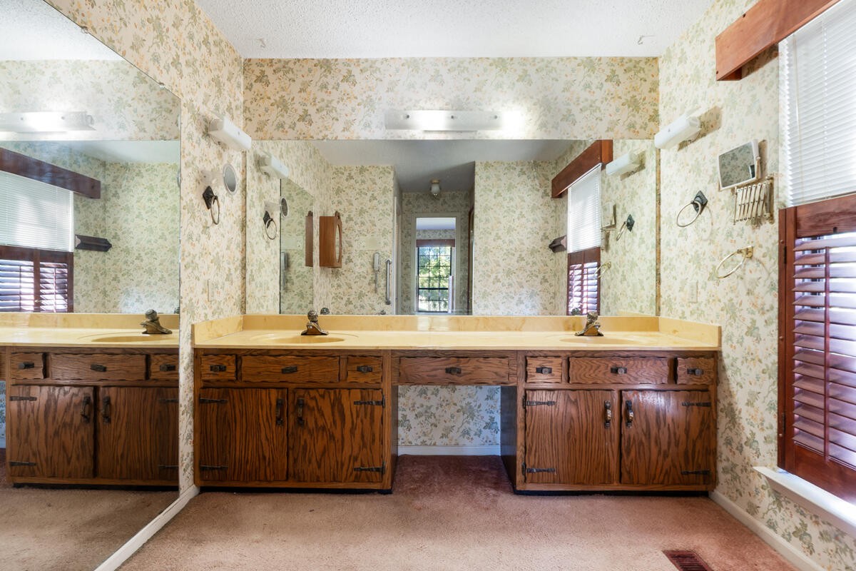 1471 New Hope Church Road Tunnel Hill, GA 30755 - Photo 15 of 45 a spacious bathroom with a sink and a large mirror