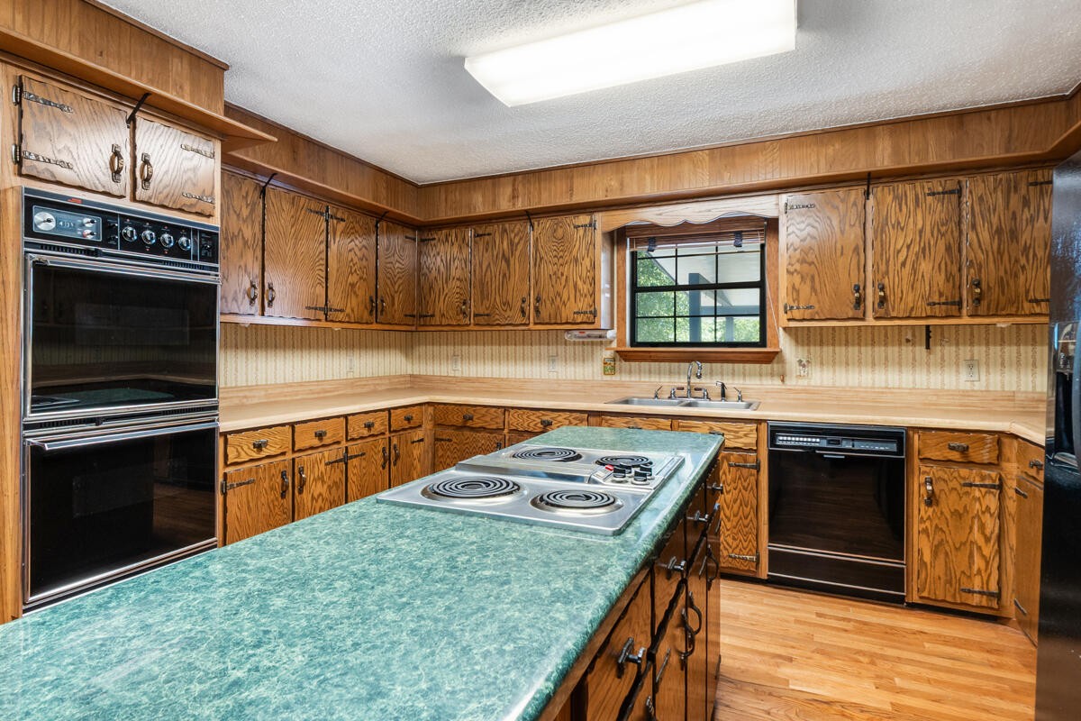 1471 New Hope Church Road Tunnel Hill, GA 30755 - Photo 20 of 45 a kitchen with stainless steel appliances granite countertop a stove sink and cabinets