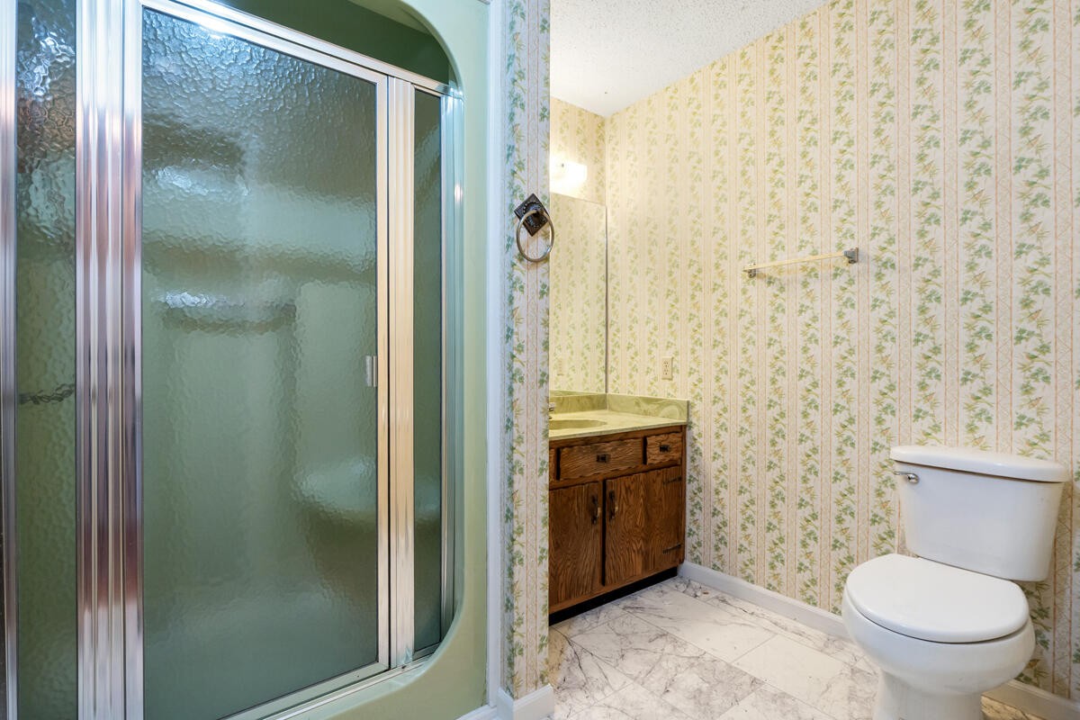 1471 New Hope Church Road Tunnel Hill, GA 30755 - Photo 21 of 45 a bathroom with a granite countertop toilet a sink and a shower