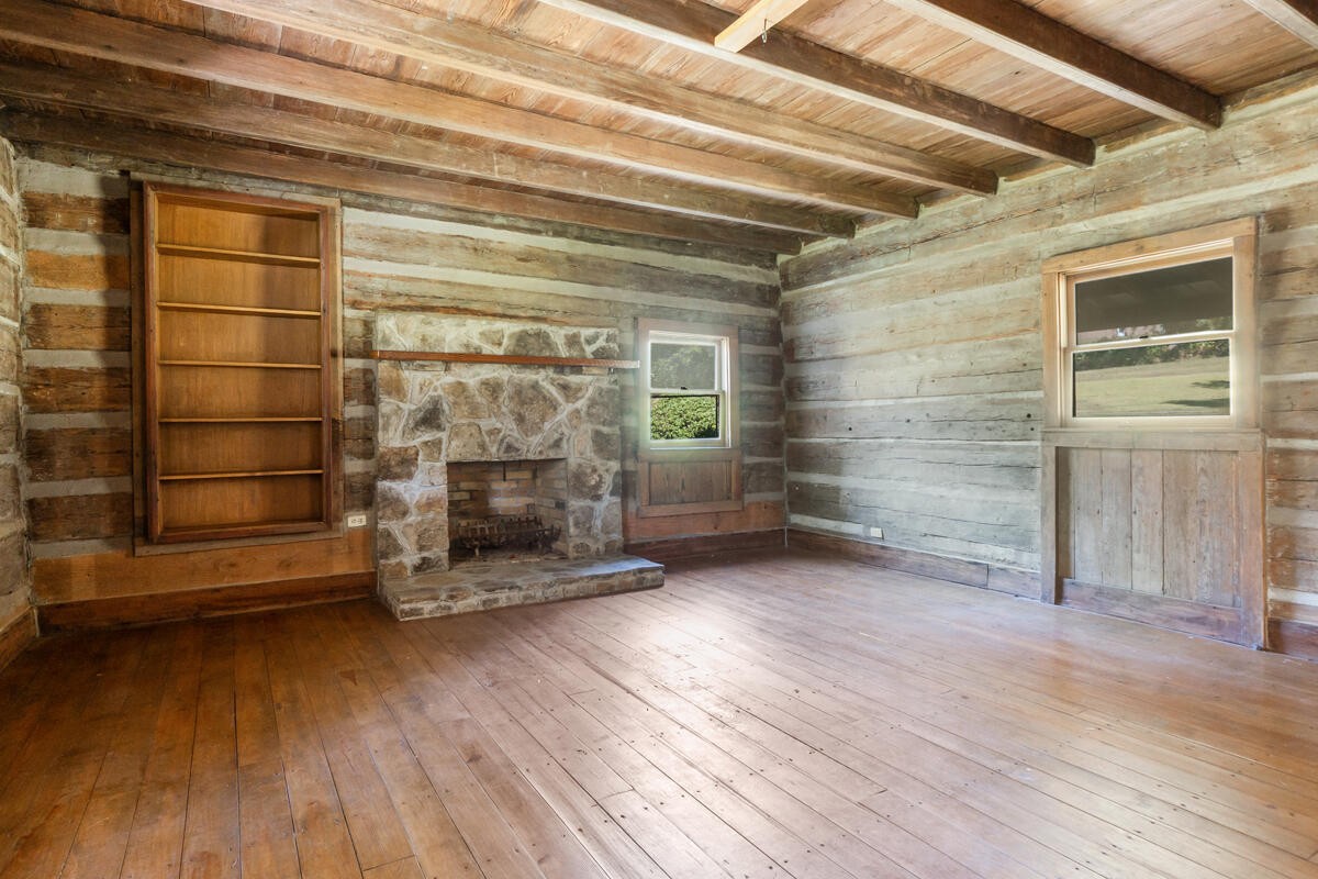 1471 New Hope Church Road Tunnel Hill, GA 30755 - Photo 31 of 45 a view of empty room with wooden floor and fireplace