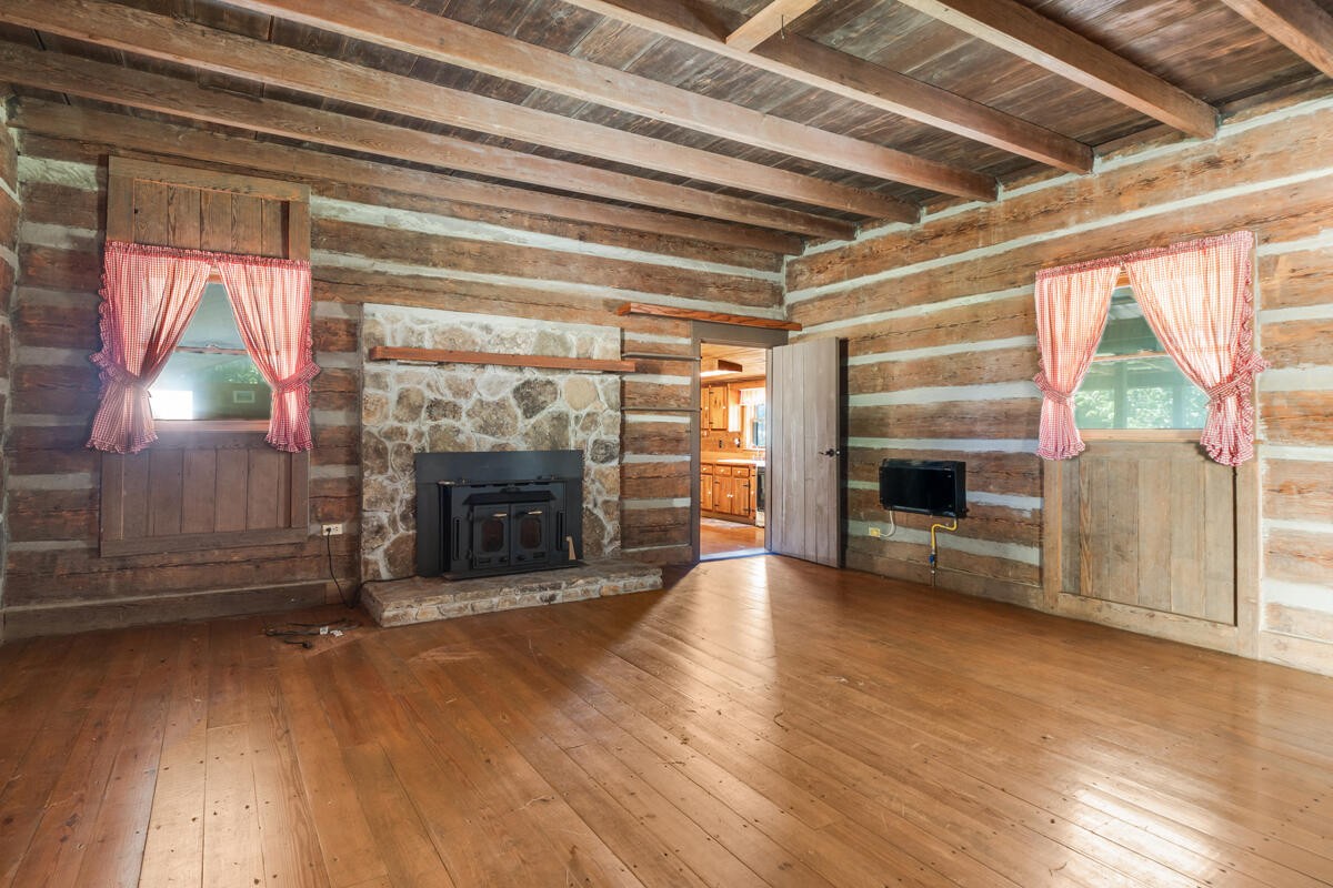 1471 New Hope Church Road Tunnel Hill, GA 30755 - Photo 33 of 45 a view of an empty room with wooden floor fireplace and a window