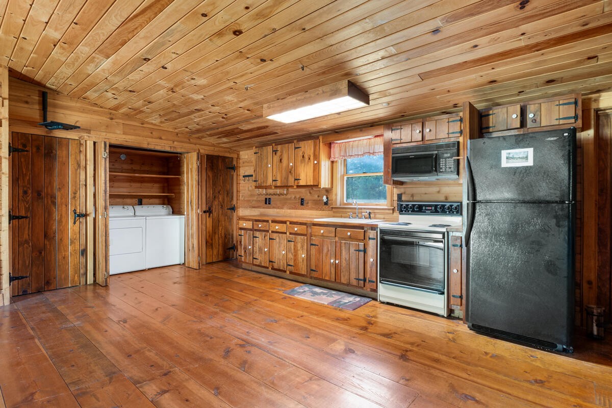 1471 New Hope Church Road Tunnel Hill, GA 30755 - Photo 35 of 45 a large kitchen with stainless steel appliances granite countertop a stove a sink and a refrigerator