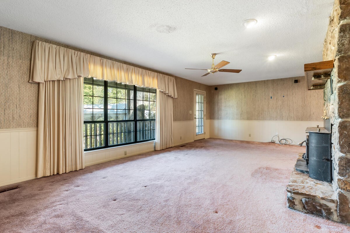 1471 New Hope Church Road Tunnel Hill, GA 30755 - Photo 10 of 45 an empty room with fireplace and windows