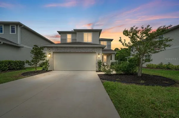 a front view of a house with a garden